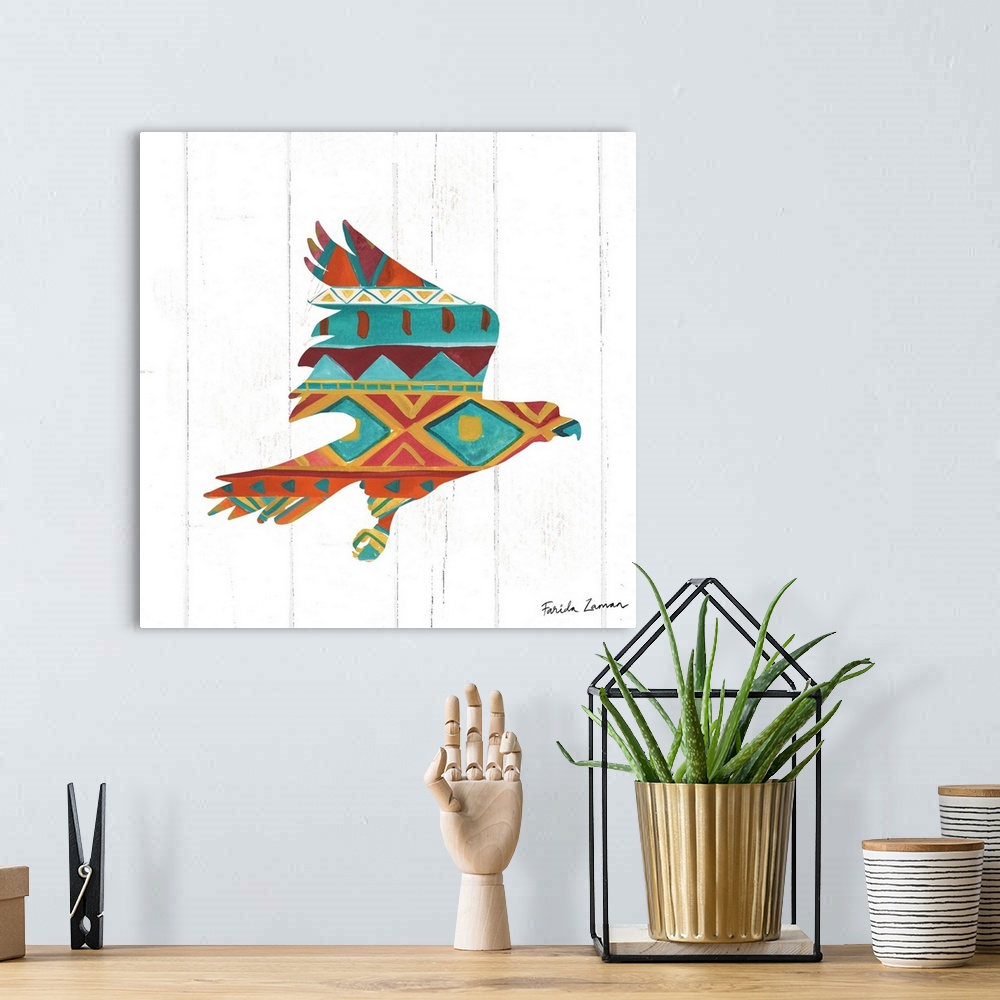 A bohemian room featuring An illustration of a hawk with a southwestern pattern on a white wood panel background.