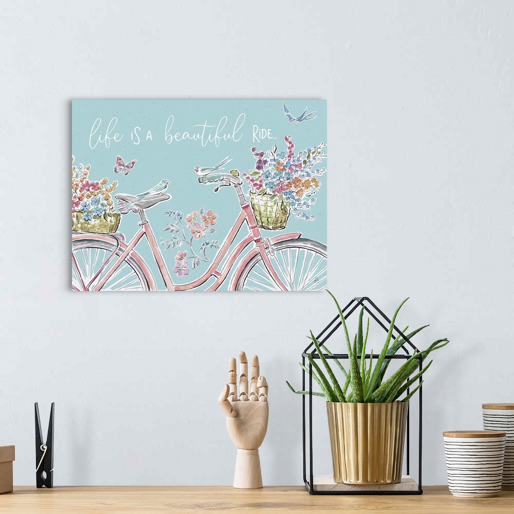 A bohemian room featuring Decorative artwork of a bicycle with flowers and the words, 'Life is a beautiful ride'.