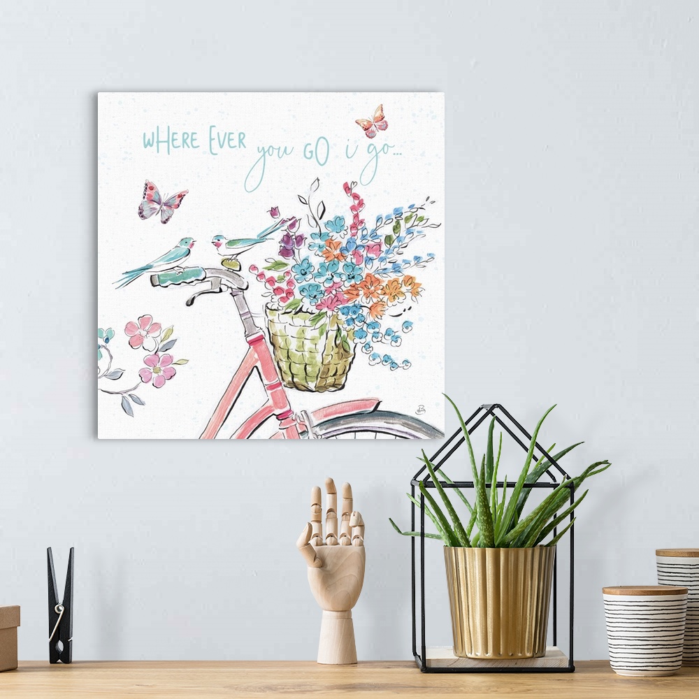 A bohemian room featuring Decorative artwork of an illustrated bike with flowers and the words, 'Where ever you go, I go......