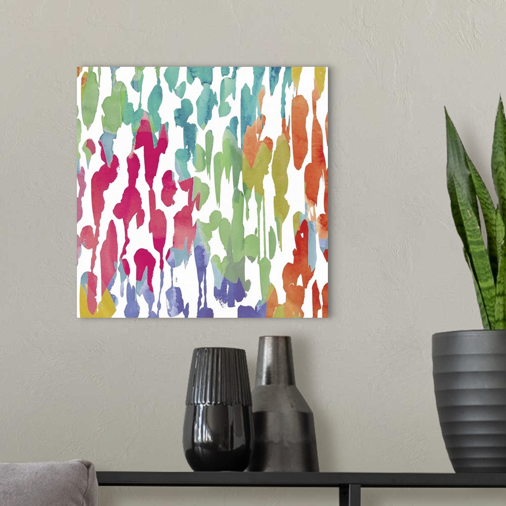 A modern room featuring Bright artwork made of varying splatters in rainbow colors.