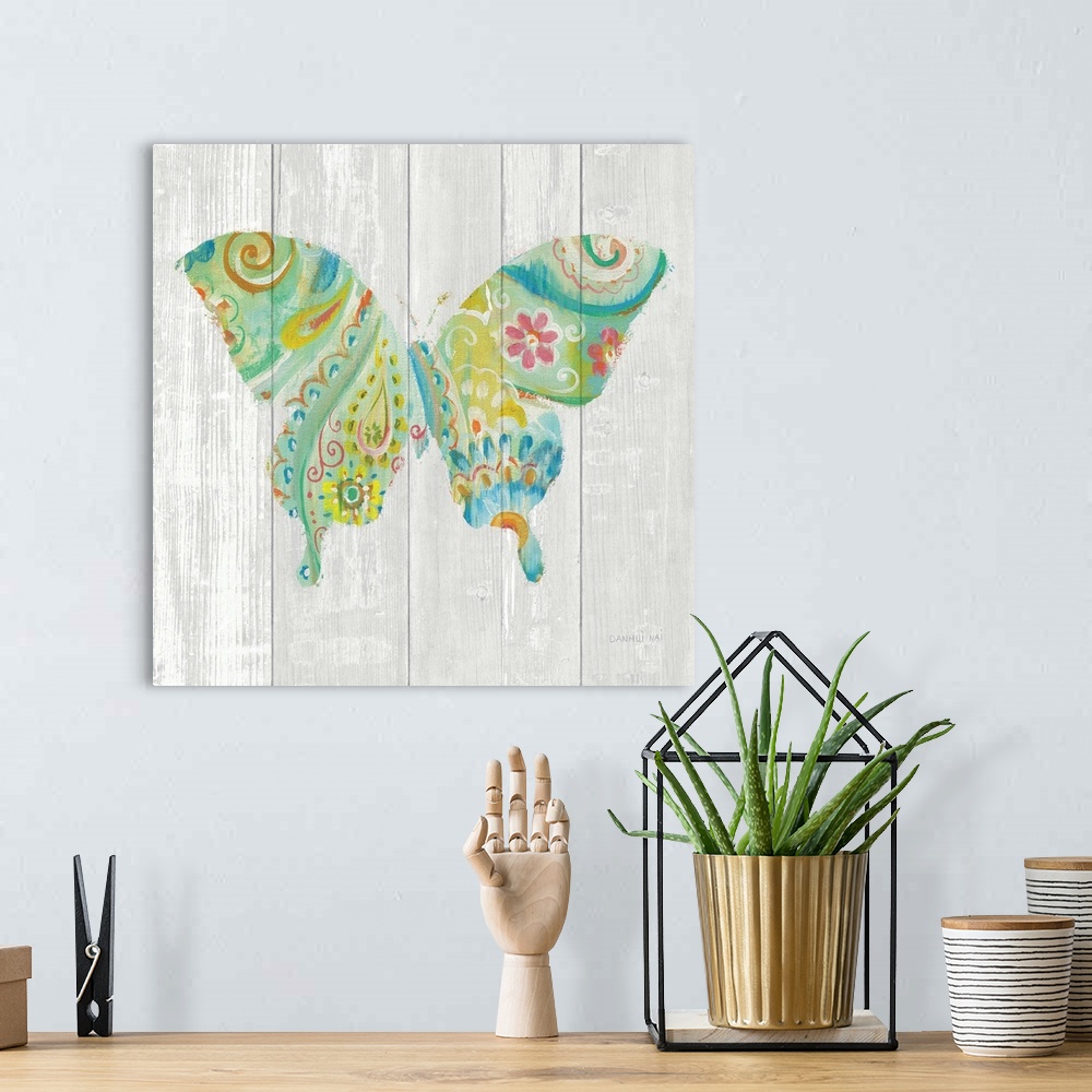 A bohemian room featuring Colorful paisley patterned butterfly against a white washed wood plank background.