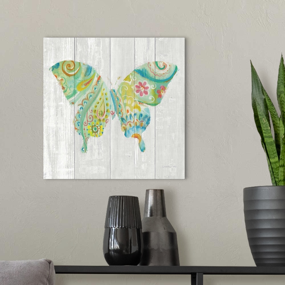A modern room featuring Colorful paisley patterned butterfly against a white washed wood plank background.