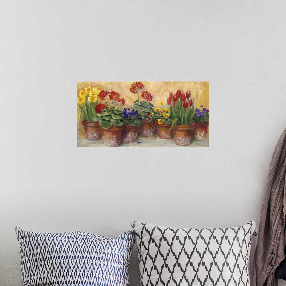 A bohemian room featuring A large horizontal painting of a row of potted flowers in warm colors.