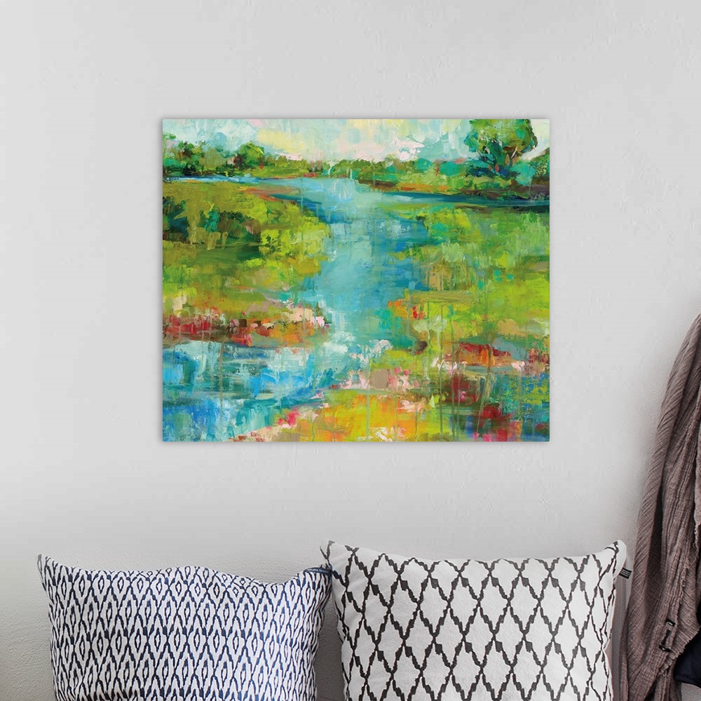 A bohemian room featuring Contemporary painting of a river running through a landscape.