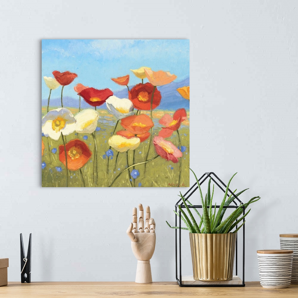 A bohemian room featuring Contemporary painting of flowers in a green field, with a blue sky above.