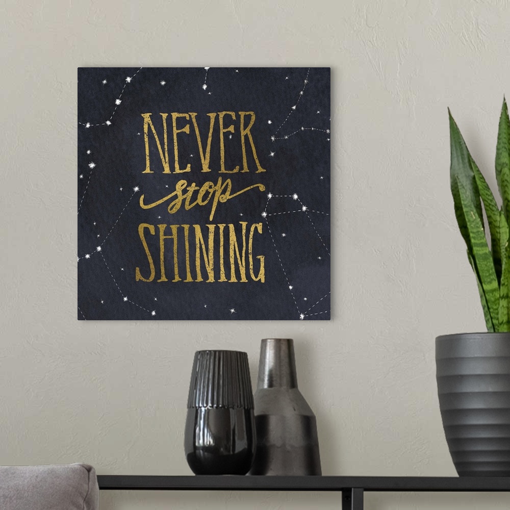 A modern room featuring Handlettered text in gold over a night sky full of constellations.