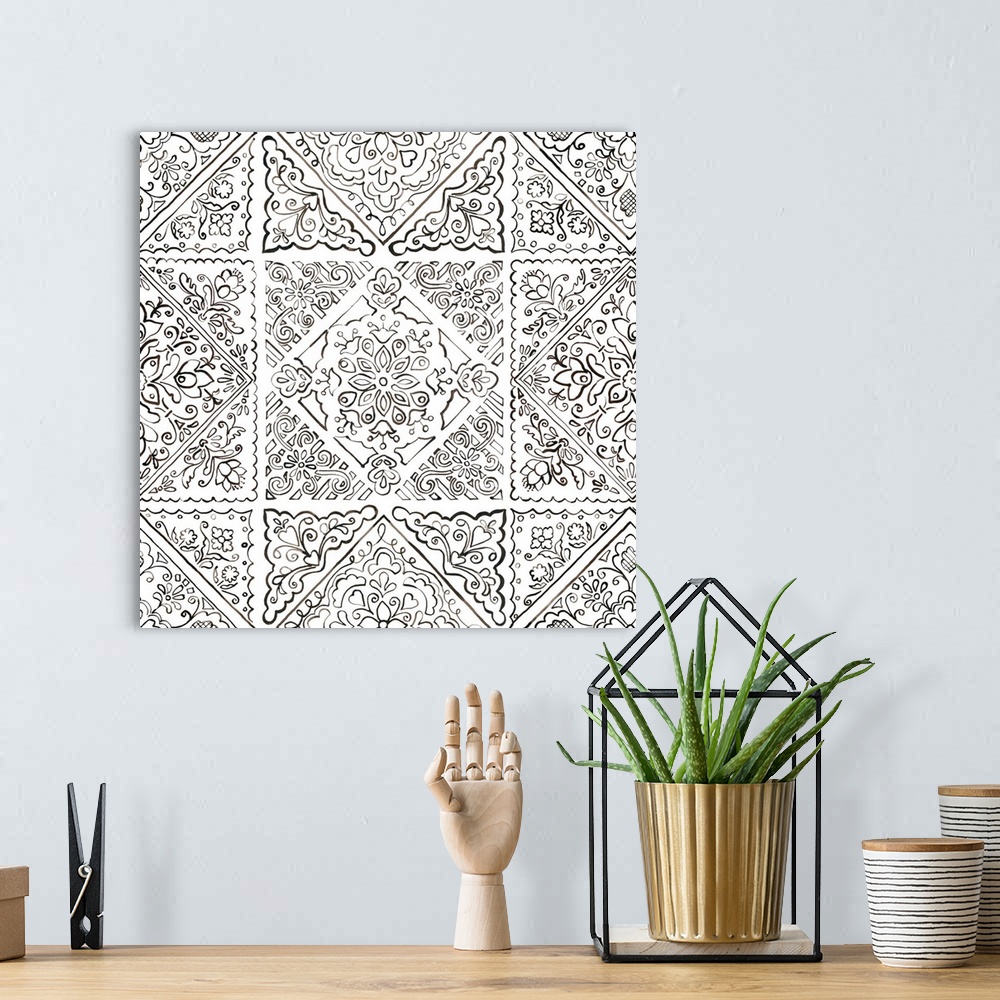 A bohemian room featuring A square decorative image of black and white floral designs in a tile pattern.