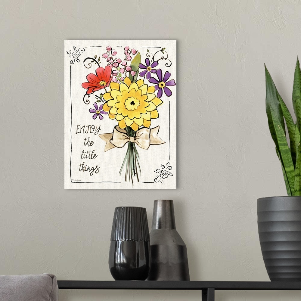 A modern room featuring "Enjoy The Little Things" written on the side of a colorful bouquet of flowers.