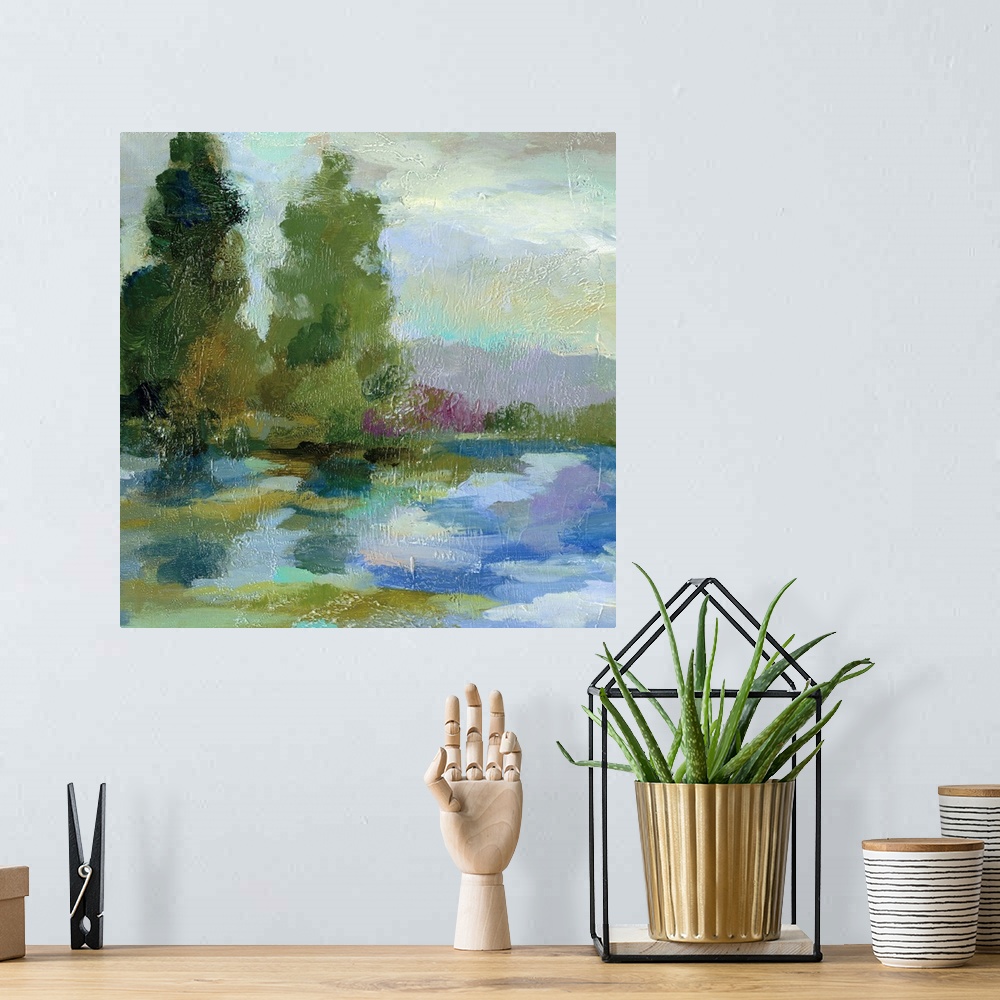 A bohemian room featuring Contemporary painting of a lake with tall trees on the shore.