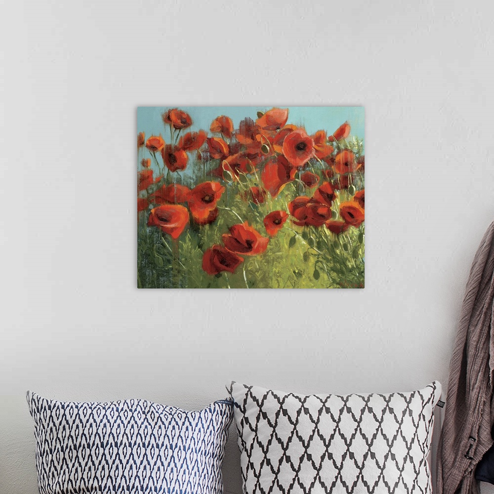 A bohemian room featuring Landscape, floral painting of many vibrant poppies in a grassy field against a blue sky.