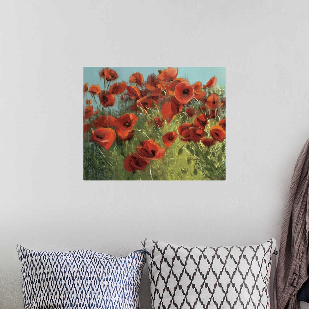 A bohemian room featuring Landscape, floral painting of many vibrant poppies in a grassy field against a blue sky.