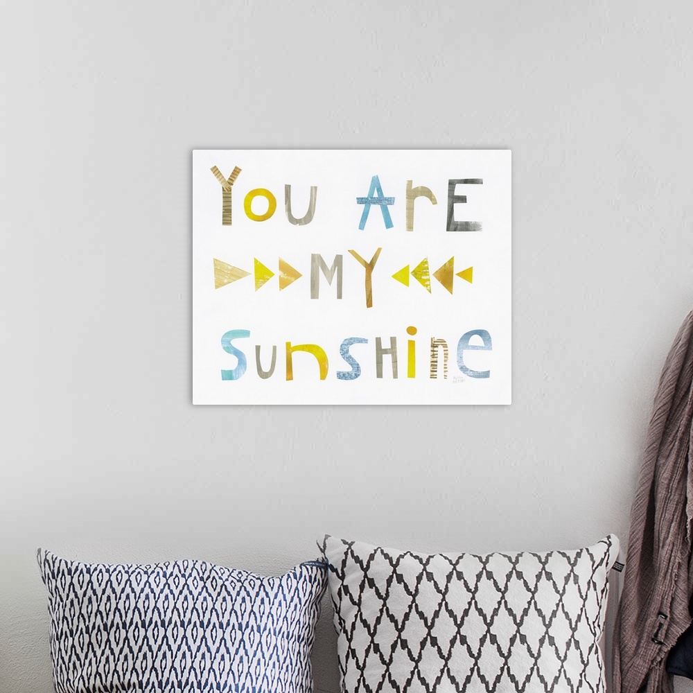 A bohemian room featuring Whimsy sentiment decor with the phrase "You Are My Sunshine" written in different colors.