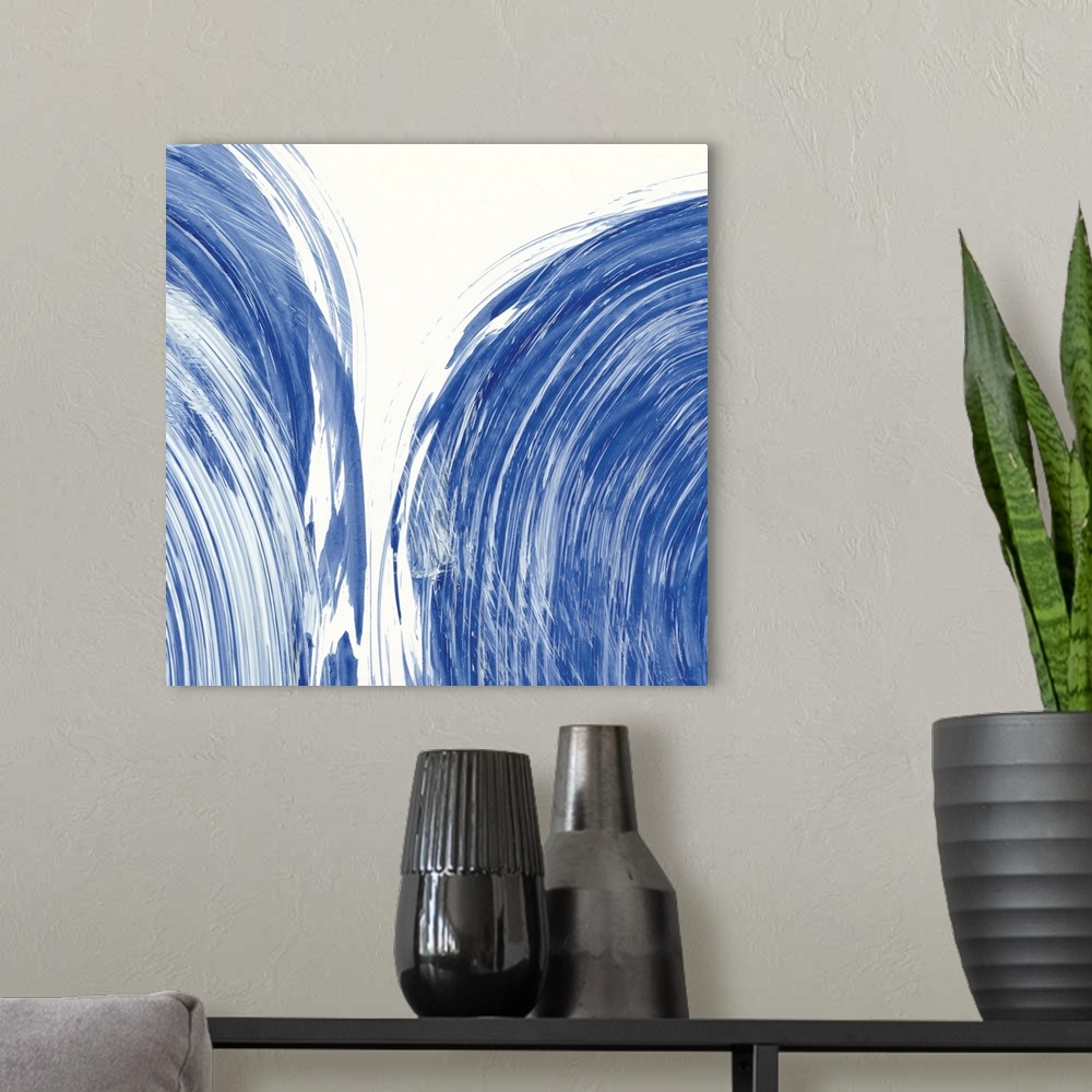 A modern room featuring Large square abstract painting of bold blue brush strokes in curved lines.