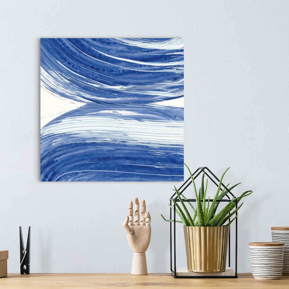 A bohemian room featuring Large square abstract painting of bold blue brush strokes in curved lines.