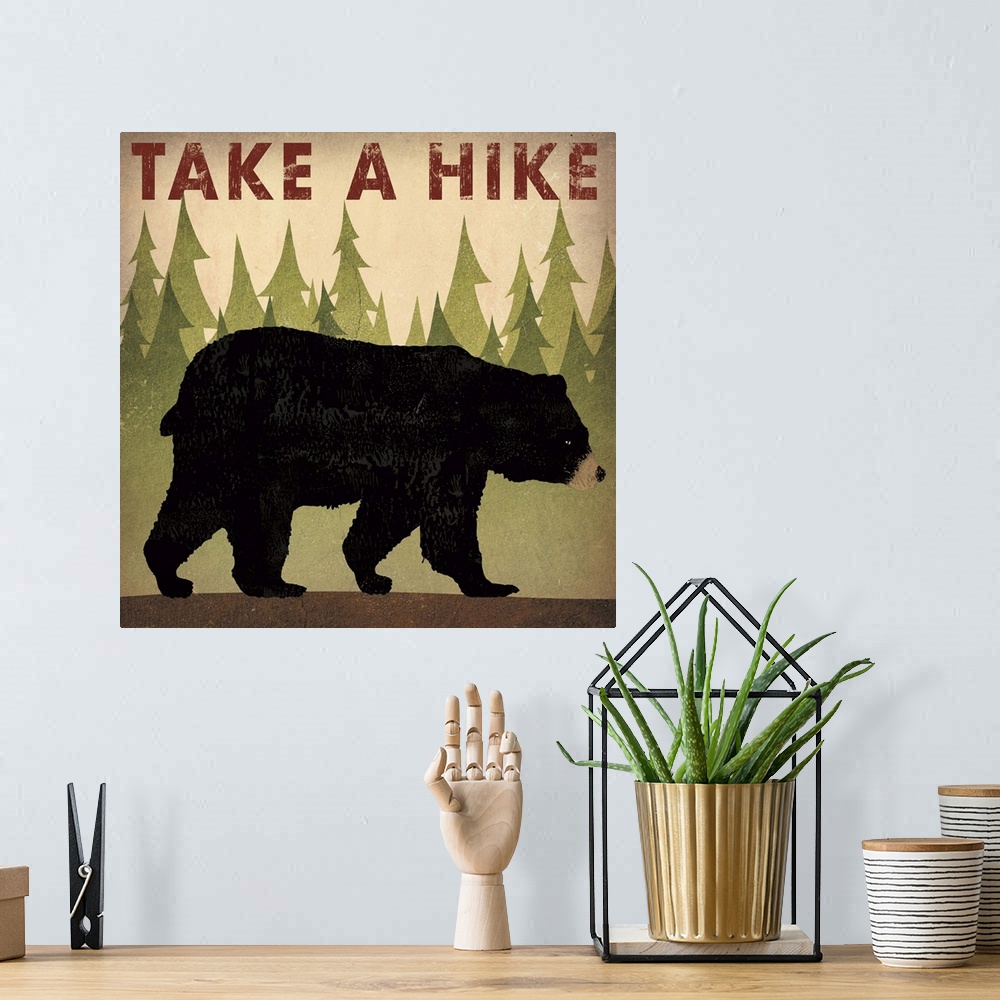 A bohemian room featuring Contemporary cabin decor artwork of a black bear sign for hiking.