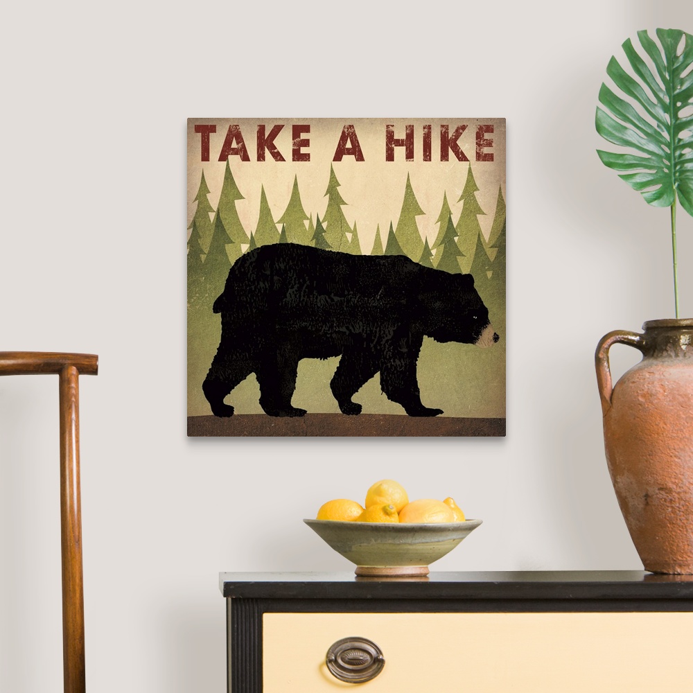 A traditional room featuring Contemporary cabin decor artwork of a black bear sign for hiking.