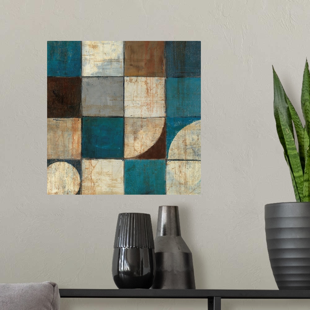 A modern room featuring Abstract painting of geometric shapes, with a couple of organic shapes all in warm and cool colors.