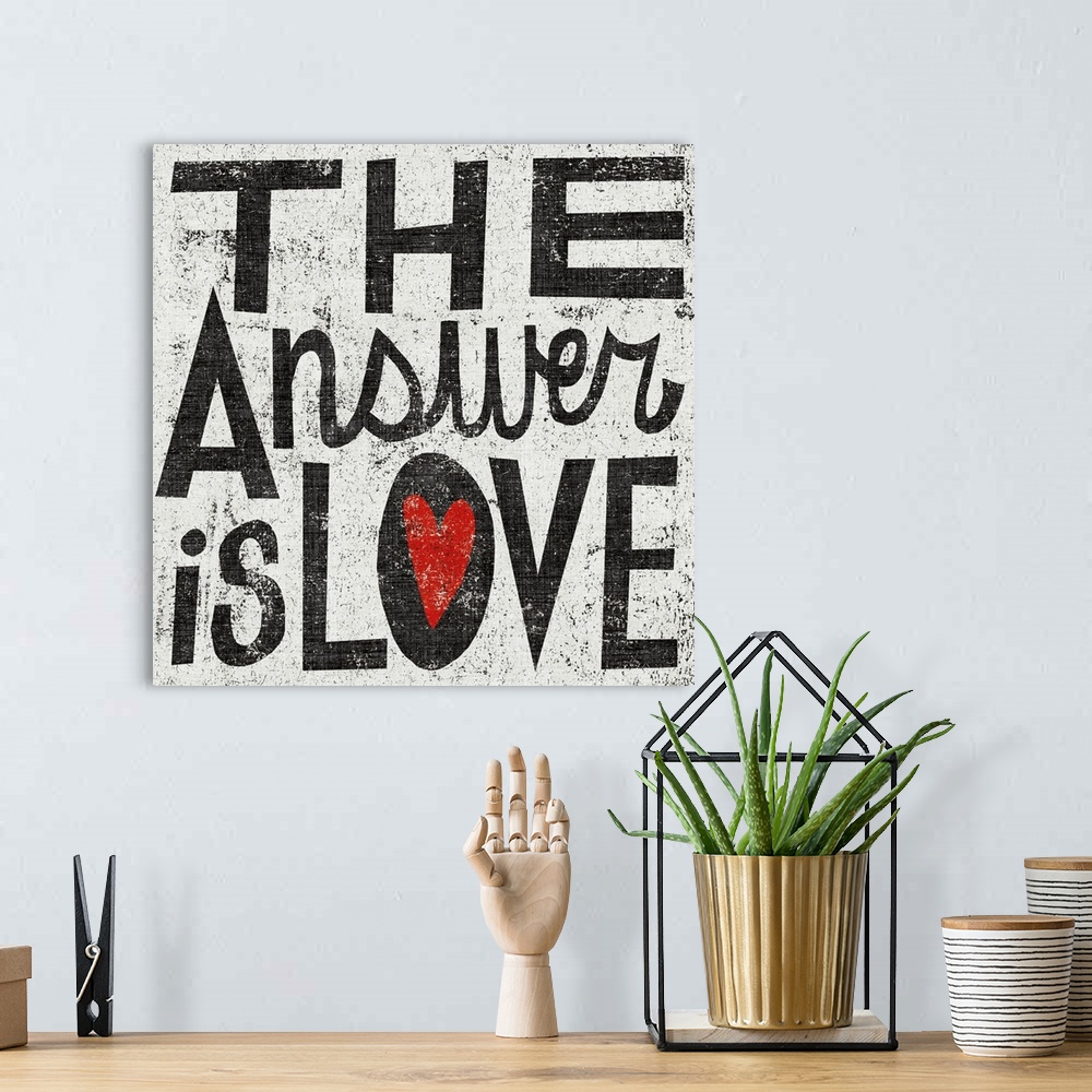 A bohemian room featuring Square painting on canvas with painted text and a grungy background.
