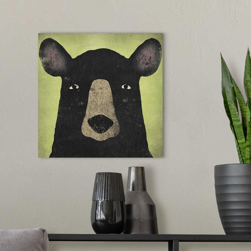 A modern room featuring Portrait of a black bear with big ears and an intense stare.