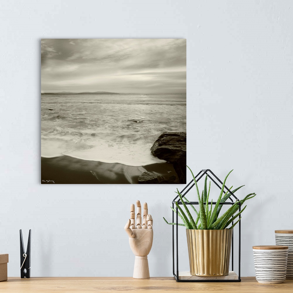 A bohemian room featuring Black and white photograph of a seascape view from a the shoreline of a beach.