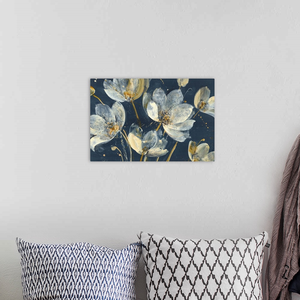 A bohemian room featuring Large abstract painting of white and gold flowers on a dark blue background.