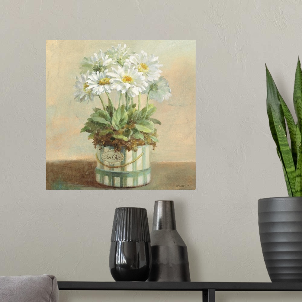 A modern room featuring Contemporary painting of white flowers in a planter sitting on a table.