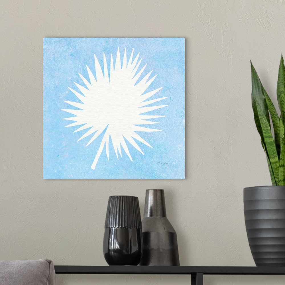 A modern room featuring White silhouette of a palm leaf on a blue square background.