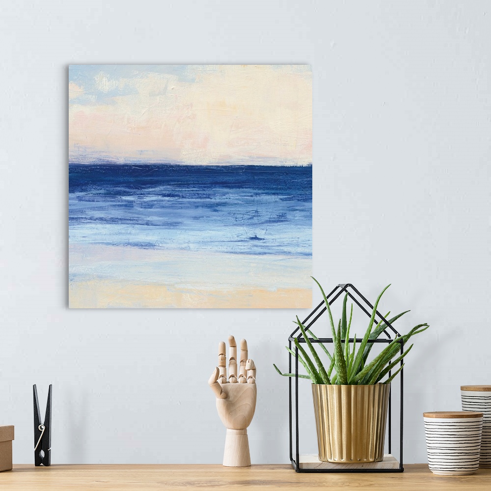 A bohemian room featuring Contemporary coastal themed painting of a calm sea seen from a beach shoreline.