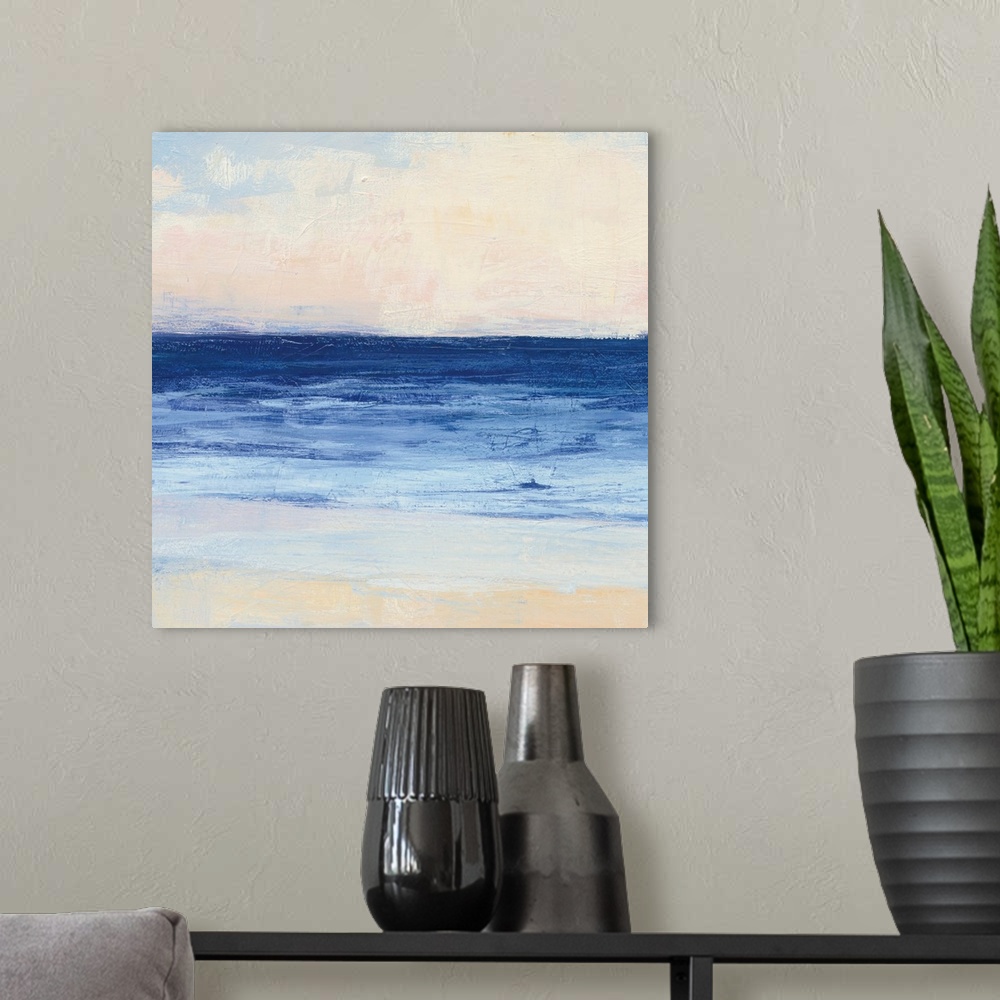 A modern room featuring Contemporary coastal themed painting of a calm sea seen from a beach shoreline.