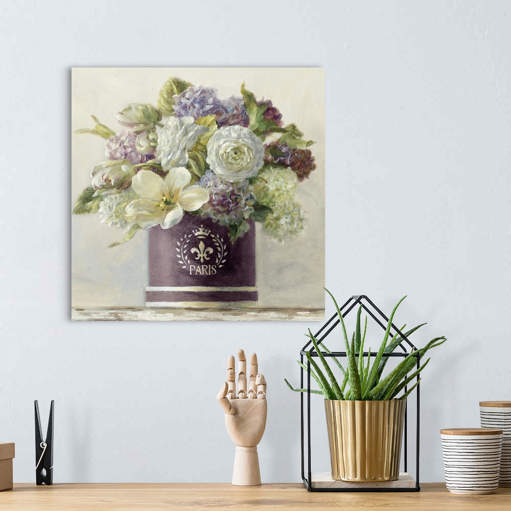 A bohemian room featuring Still life painting of a hatbox filled with a variety of flowers against a soft background.