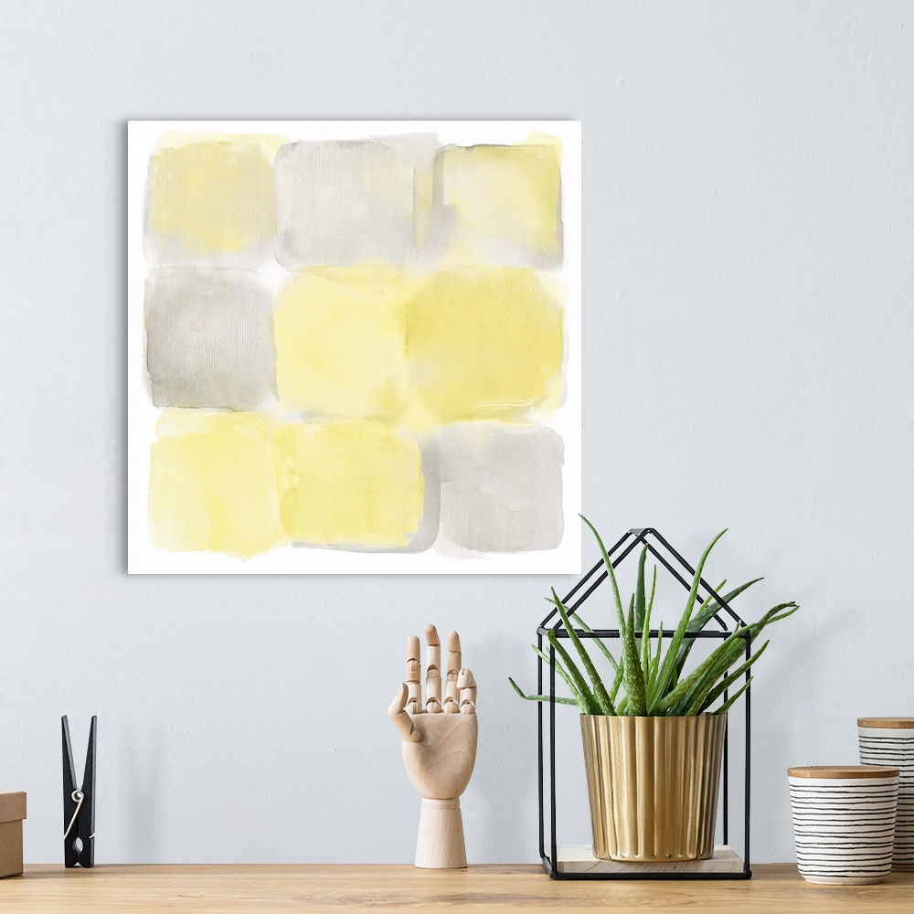 A bohemian room featuring Simple watercolor painting of yellow and gray square shapes.