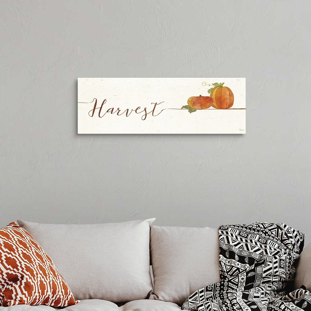 A bohemian room featuring Horizontal artwork of "Harvest" in handwritten text with a pair of pumpkins.