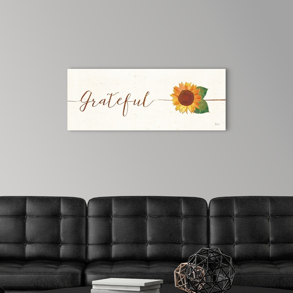 A modern room featuring Horizontal artwork of "Grateful" in handwritten text with a sunflower.