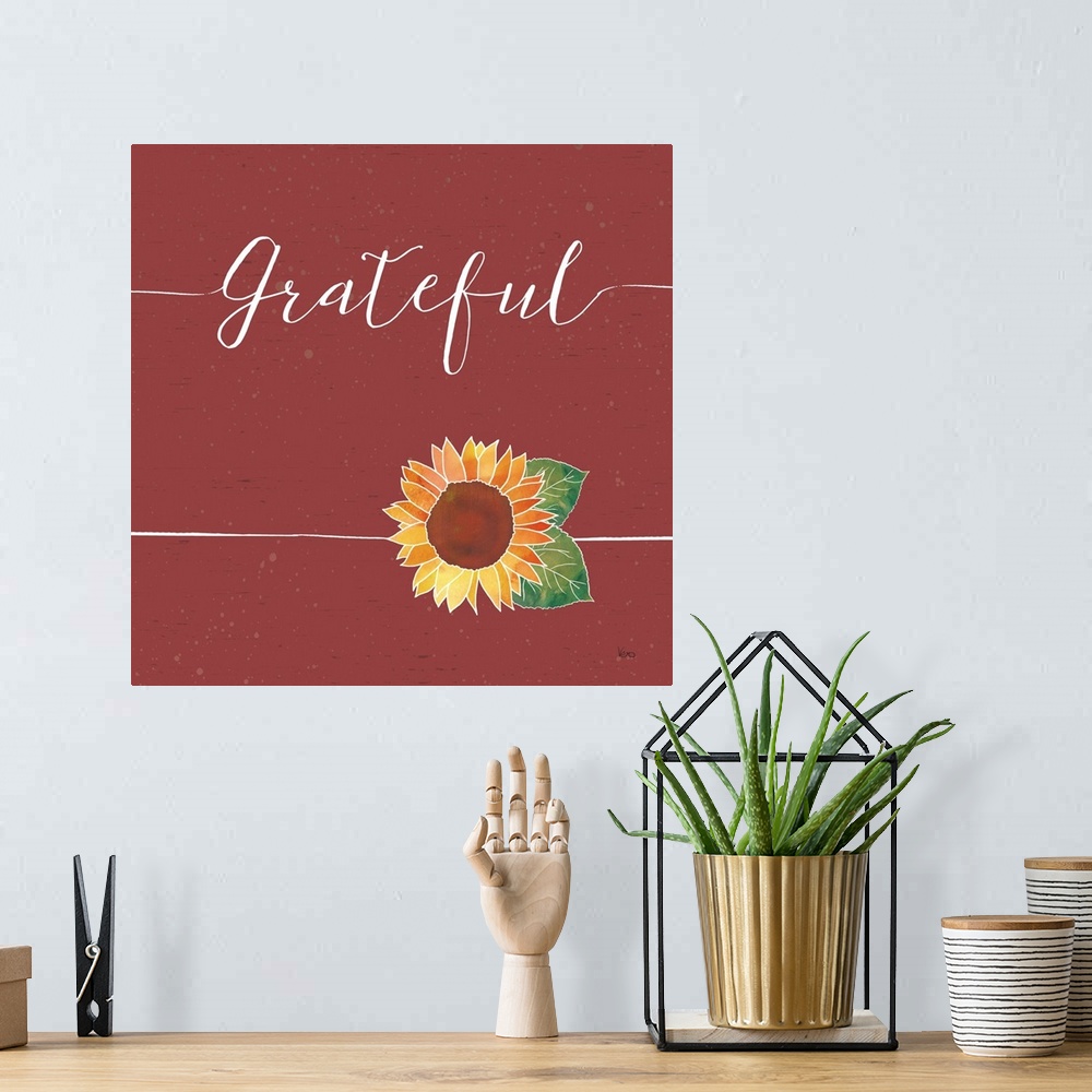 A bohemian room featuring "Gratetful" with a sunflower on a wood textured red background.