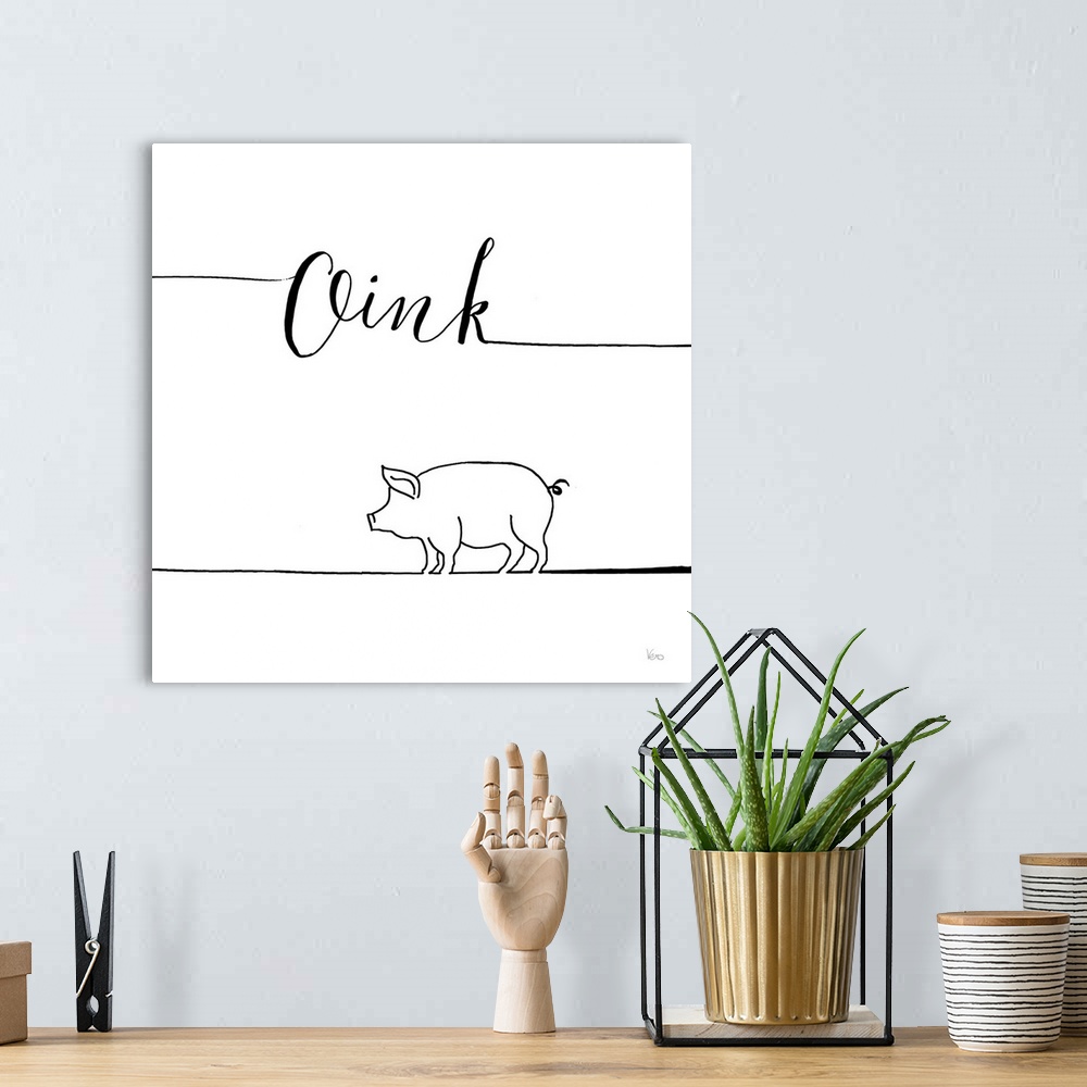 A bohemian room featuring A simple black and white design of a pig with the text "Oink".