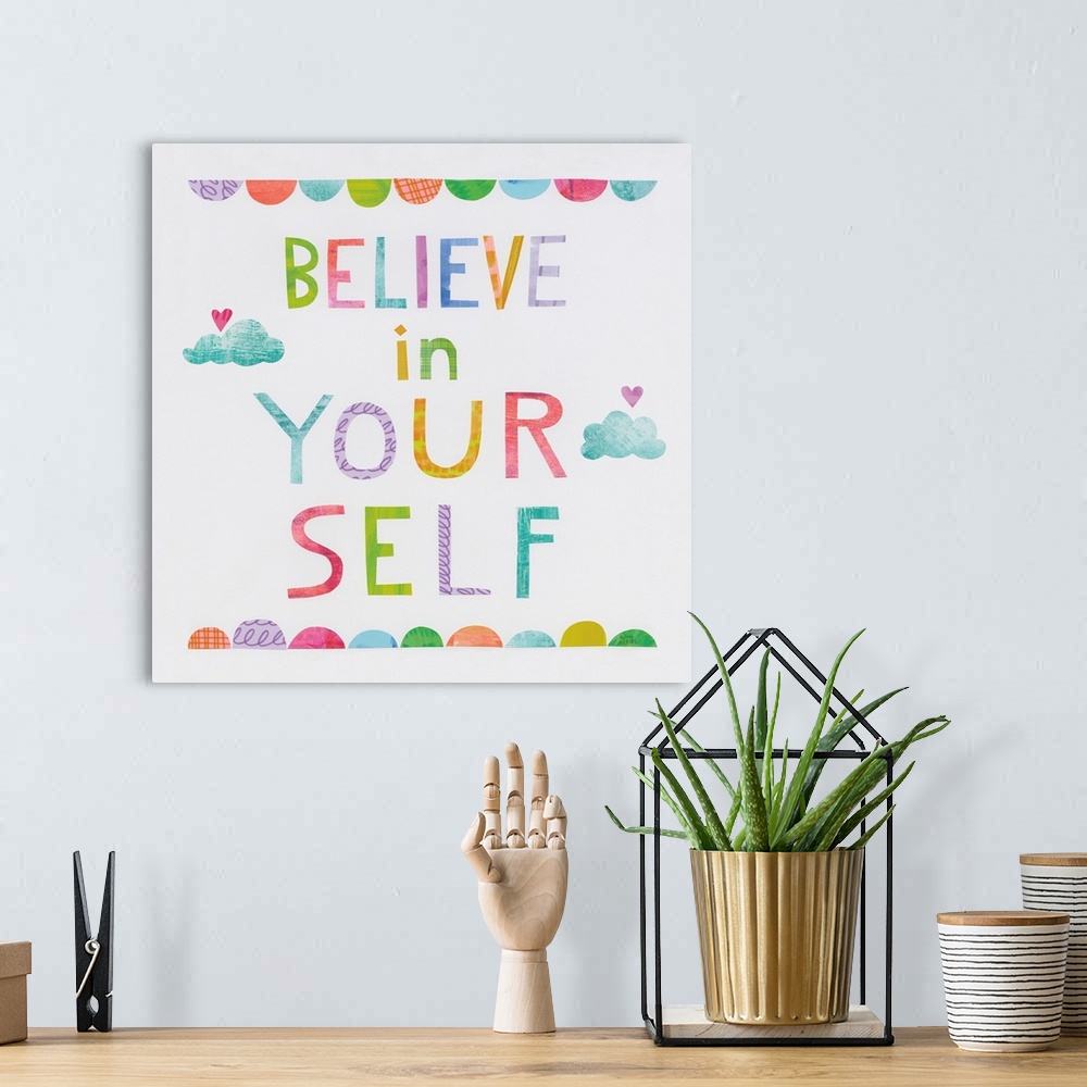 A bohemian room featuring Whimsy inspirational decor with the phrase "Believe In Yourself" written in different colors.