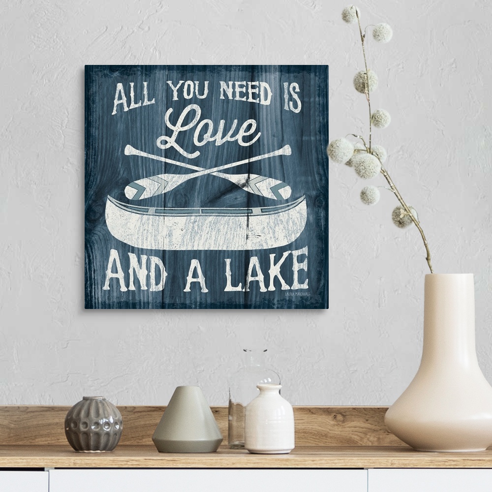 A farmhouse room featuring "All You Need is Love And a Lake" in white with an illustration of a canoe and paddles on a dark ...