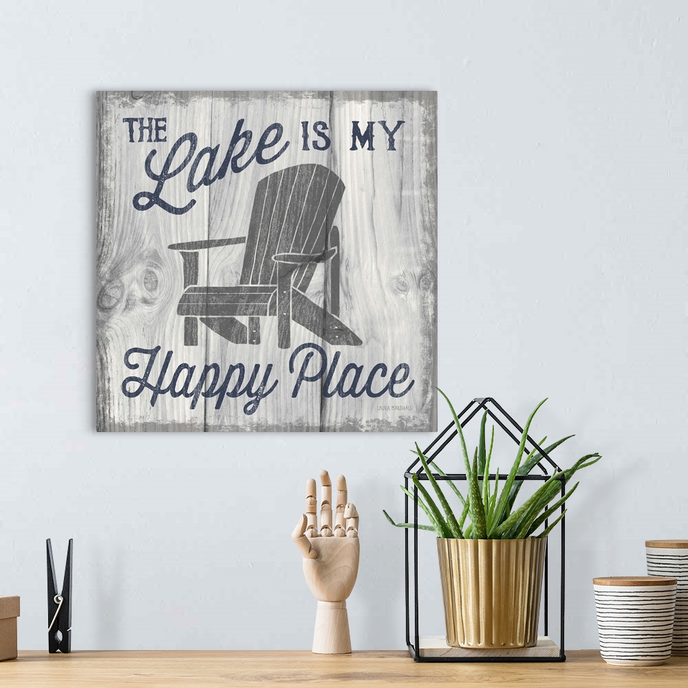 A bohemian room featuring "The Lake is My Happy Place" in navy blue with an illustration of an adirondack chair on a white ...
