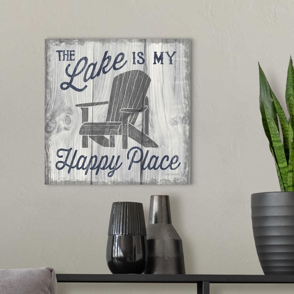 A modern room featuring "The Lake is My Happy Place" in navy blue with an illustration of an adirondack chair on a white ...