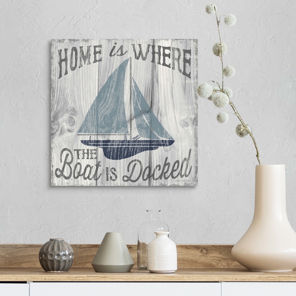 A farmhouse room featuring "Home is Where the Boat is Docked" in grey with an illustration of a sailboat in shades of blue o...