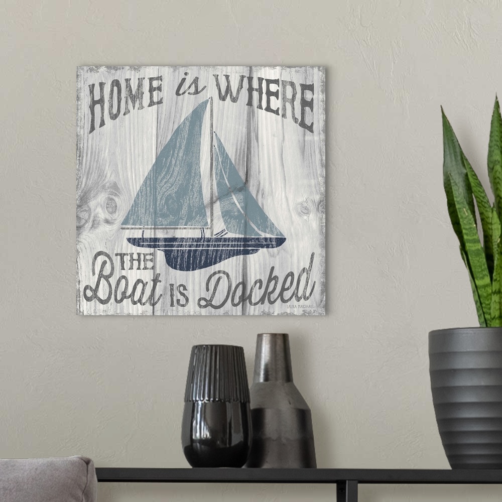 A modern room featuring "Home is Where the Boat is Docked" in grey with an illustration of a sailboat in shades of blue o...