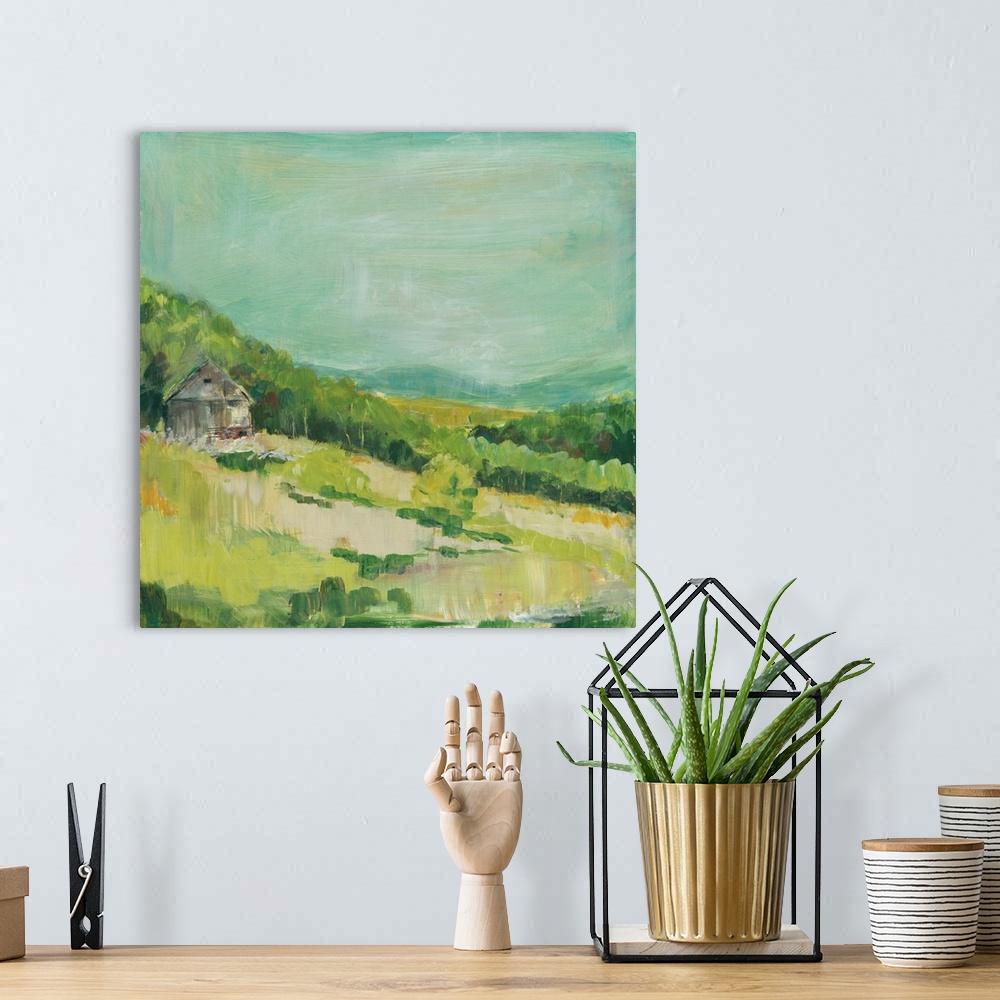 A bohemian room featuring Contemporary painting of a small house on a hillside covered in green trees and grass.
