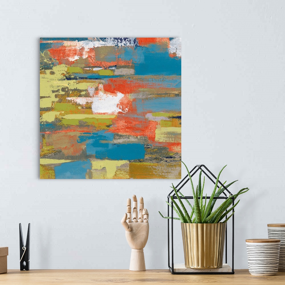 A bohemian room featuring Large abstract painting made with shades of green, blue, gray, orange, and white on a square canvas.