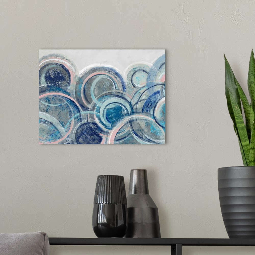 A modern room featuring Contemporary abstract artwork featuring an array of blue circles over a light gray background.
