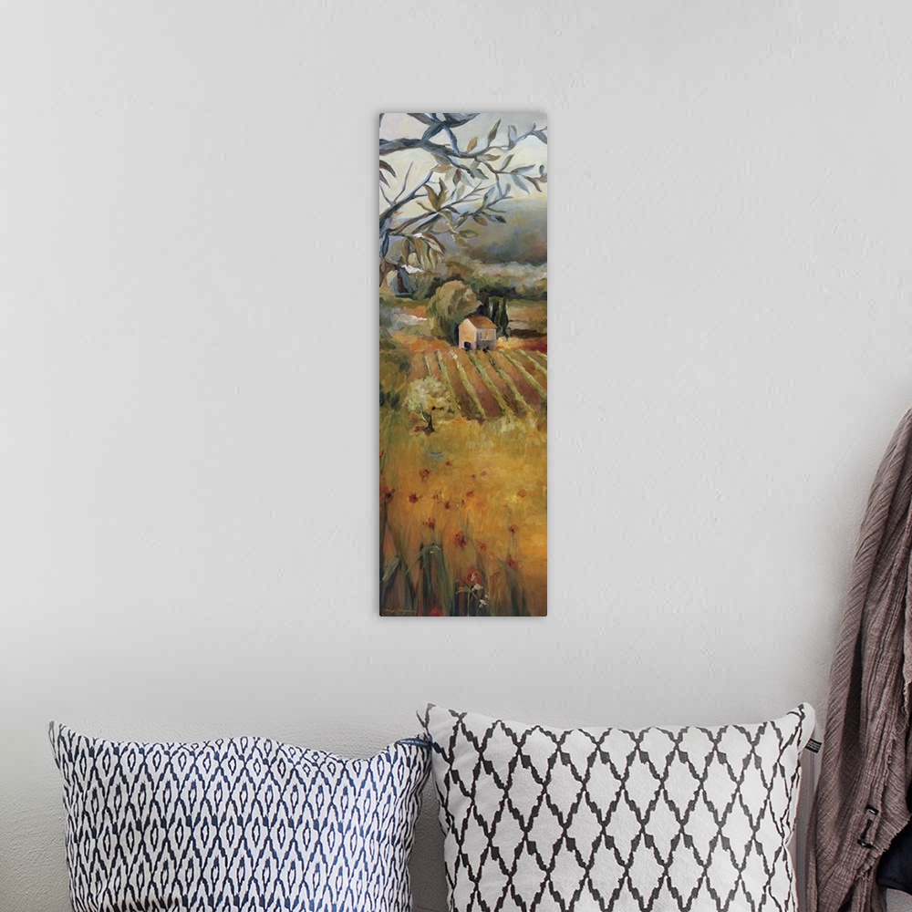 A bohemian room featuring Oversized, vertical panting, looking down onto a golden field in front of a vineyard, a dense tre...