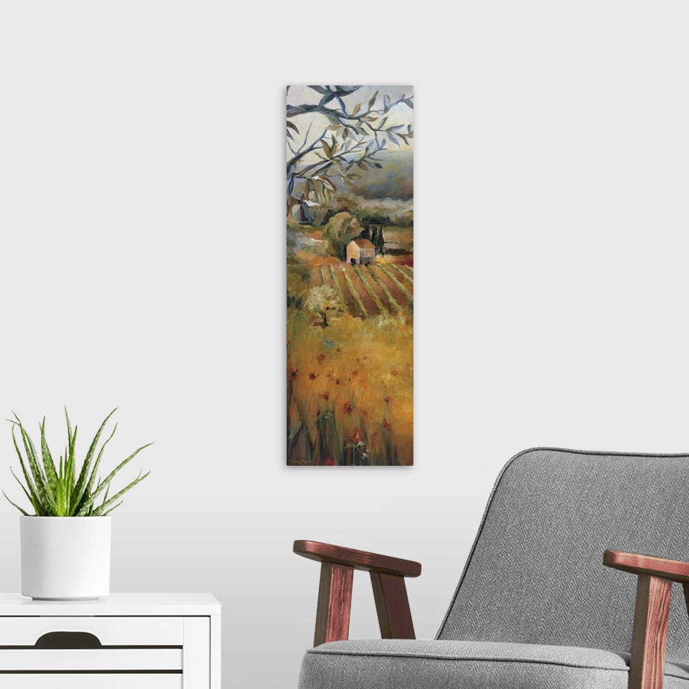 A modern room featuring Oversized, vertical panting, looking down onto a golden field in front of a vineyard, a dense tre...