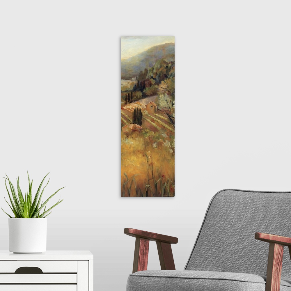 A modern room featuring Giant, vertical painting overlooking a golden vineyard, surrounded by trees and mountains in the ...