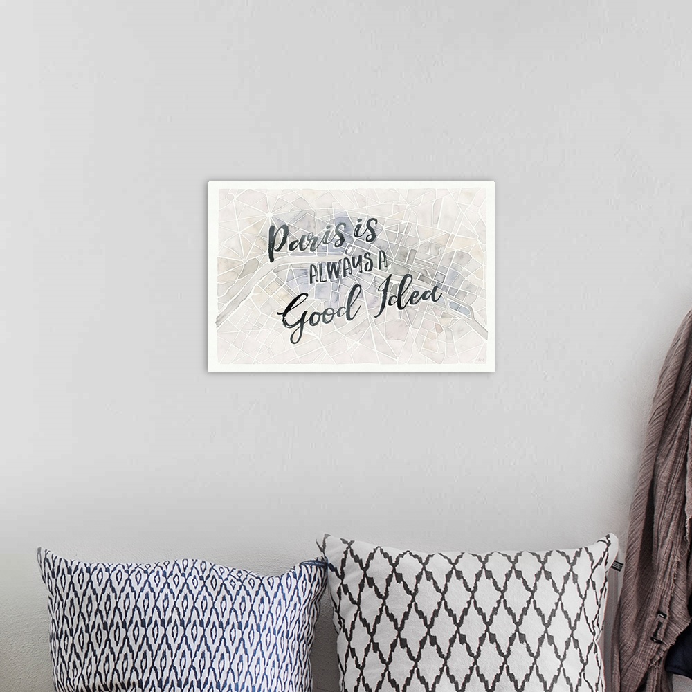 A bohemian room featuring "Paris is Always a Good Idea" handwritten on top of a watercolor aerial street map of Paris, France.