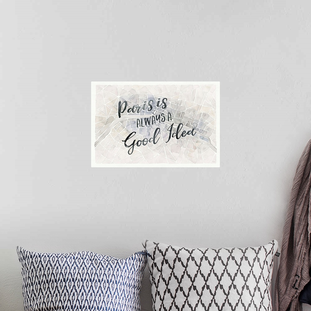A bohemian room featuring "Paris is Always a Good Idea" handwritten on top of a watercolor aerial street map of Paris, France.