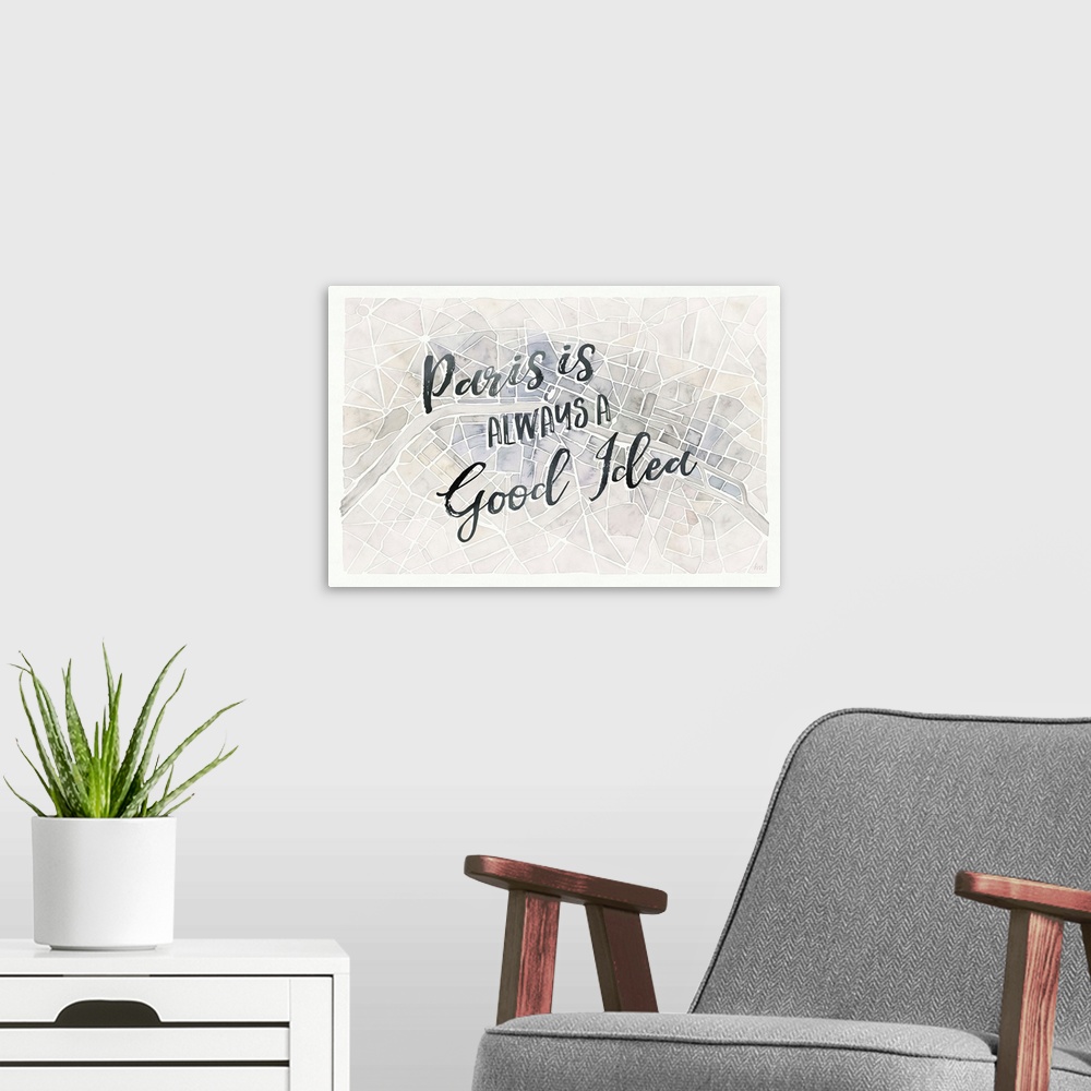 A modern room featuring "Paris is Always a Good Idea" handwritten on top of a watercolor aerial street map of Paris, France.